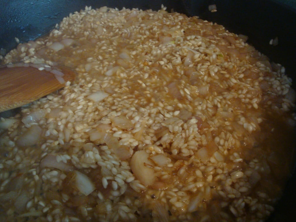 stirring risotto with a wooden spoon